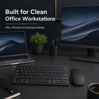 Modern office setup with laptop, monitor, keyboard, mouse, and decor on a dark desk.