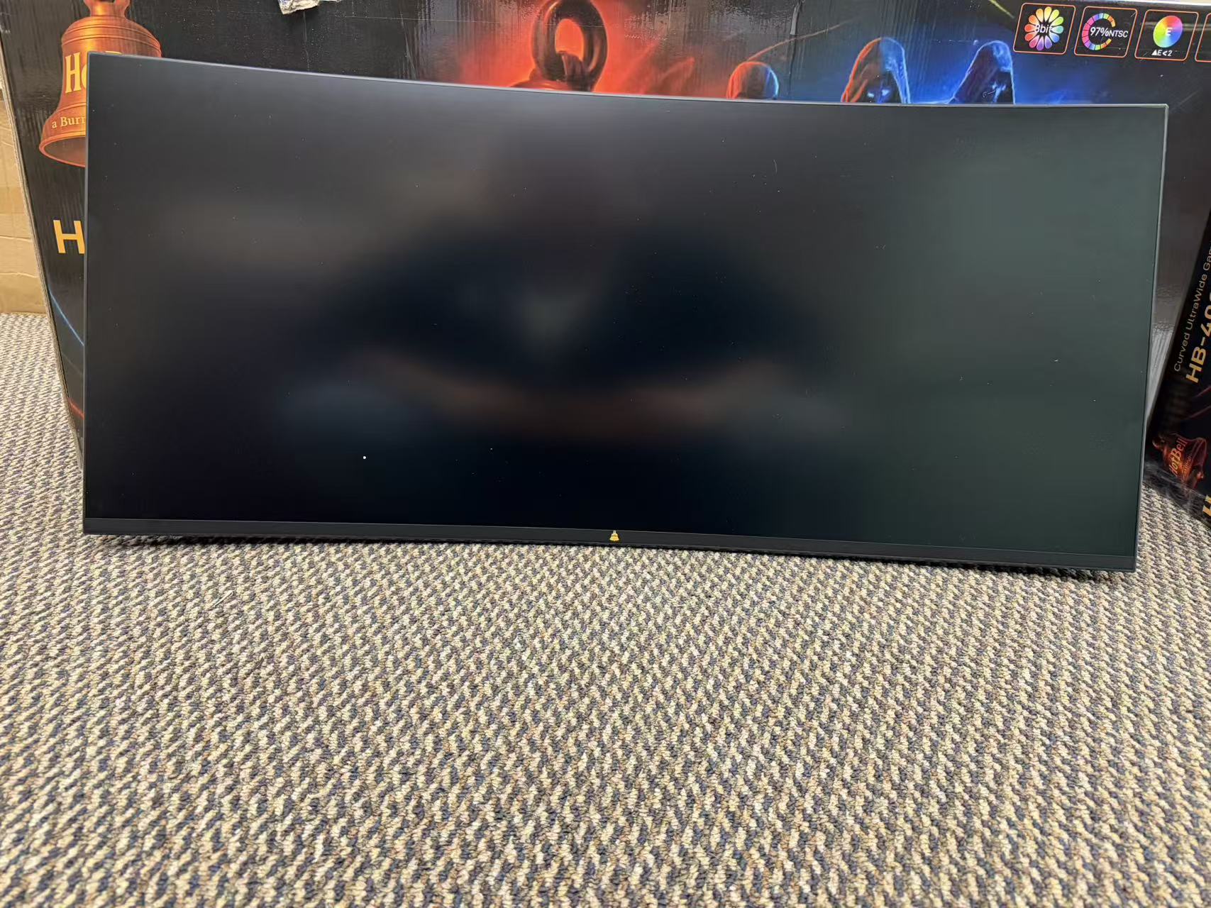 HotBell 40-inch curved gaming monitor with blank screen displayed in front of its retail packaging
