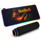 HotBell extended RGB gaming desk mat with dragon and bell artwork, shown flat and rolled on a white background